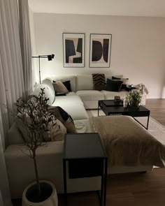 a living room filled with lots of furniture next to a wall mounted art piece on the wall