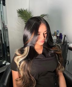 a woman sitting in a chair with long hair