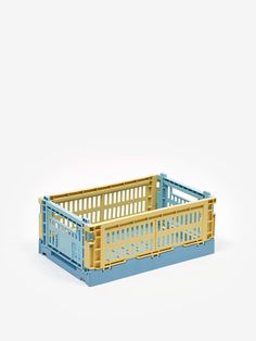 a blue and yellow crate sitting on top of a white surface