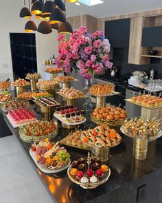 a table filled with lots of different types of food on top of it's trays