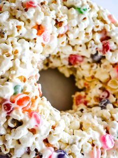 a close up of a cake with marshmallows on it and the words, popcorn & candy marshmallow cake