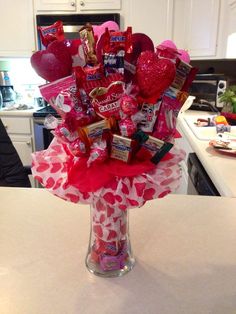 a vase filled with candy and candies on top of a counter