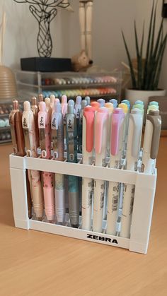 a pen holder filled with lots of different pens