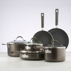 an assortment of pots and pans on a table