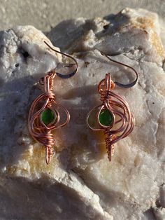 Cat eye enclosed in copper! Love the green Green Copper Wire Earrings Gift, Unique Green Metal Earrings, Green Bohemian Earrings With Copper Wire, Bohemian Green Earrings With Copper Wire, Green Bohemian Copper Wire Earrings, Green Copper Earrings For Gift, Green Wire Wrapped Metal Earrings, Handmade Copper Green Earrings, Handmade Green Copper Earrings