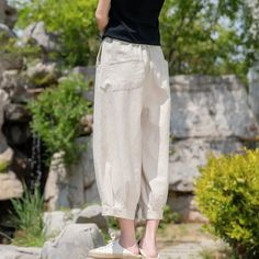 Discover Women's Linen Pants Embrace comfort and style with our Bohemian Casual Tapered Pants, perfect for the free-spirited woman who values both relaxation and fashion-forward looks. Key Features: Fabric: Crafted from high-quality linen for a breathable and soft feel Style: Unique harem pants/cropped pants design for a Bohemian flair Fit: Loose fit with a mid-waist design for ultimate comfort Length: Cropped Pants with a tapered cut for a modern silhouette Details: Features retro elements that add a touch of nostalgia Size: Available in one size that fits waist 66-96cm/25-37" and hip 108cm/42" Uncover the perfect blend of comfort and elegance with our women's linen pants. Crafted from premium linen, these tapered trousers embody a relaxed Bohemian vibe. making them ideal for both casual Bohemian Style Cream Bottoms With Elastic Waistband, Cream Bohemian Pants For Spring, Beige Relaxed Fit Harem Pants For Spring, White Relaxed Fit Harem Pants With Straight Leg, Spring Bohemian Tapered Leg Pants, Bohemian Spring Harem Pants With Tapered Leg, Spring Bohemian Harem Pants With Tapered Leg, Bohemian Harem Pants With Tapered Leg For Spring, Beige Bohemian Pants With Pockets