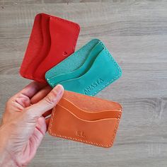 The ideal leather card sleeve that perfectly fits in your pocket or bag for everyday use.  This slim card holder is made from genuine calf leather of vibrant colours. The card case has two slots  that easily fit 2-4 cards. The stitching is made with a strong thread for leather. Dimensions: 7 x 10 cm ( 2.36 x 3.94 inches) Available colours: ocher, yellow, pink, light pink, green, mint green, light blue, blue, red, peach, burgundy and purple. ADD PERSONALISATION I stamp the initials/name/date/text Leather Card Holder With Slots As Gift, Classic Red Card Holder For Gift, Everyday Red Card Holder With Card Slots, Classic Handmade Card Holder Gift, Functional Leather Bifold Card Holder, Orange Leather Wallet As Gift, Orange Card Holder With Card Slots For Everyday Use, Red Card Holder With Interior Slots For Gift, Everyday Red Card Holder With Slots