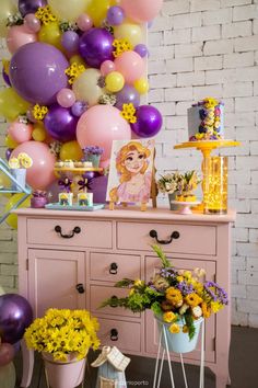 a table with flowers and balloons on it