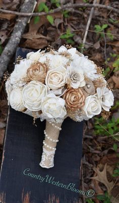 a bridal bouquet with white and brown flowers