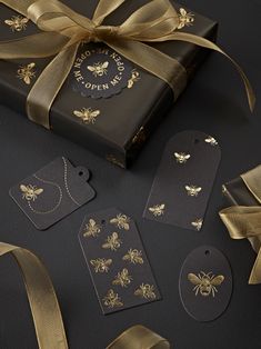 the package is wrapped in gold ribbon and has bees on it