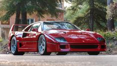 a red sports car is parked on the street