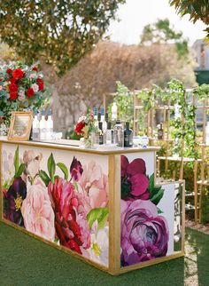 an outdoor bar with flowers painted on it