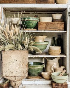 an old cabinet filled with dishes and bowls