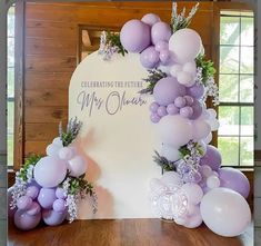 a table with balloons and flowers on it