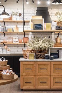 an open kitchen with lots of shelves and baskets on the counter, along with other items