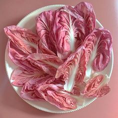 some pink lettuce on a white plate