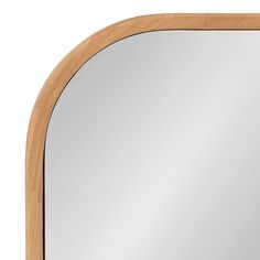 a wooden frame mirror with a white background and light wood trimmings on the edges