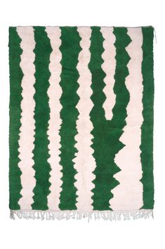 a green and white striped rug with fringes