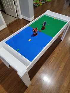 a table with legos on it in the middle of a room