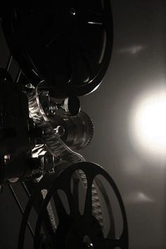 an old movie projector with the sun in the background