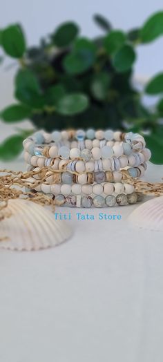 TitiTataStore.com Always FREE SHIPPING and a FREE GIFT! I Will Ship Within 24 Hours Description:  A Set of 5 Beachy Style Handmade Bracelets.  Beautiful Summer Beach Vacation Vibes Accessories! Materials: 6mm Natural Impression Sea Sediment Jasper Matte Beads, 6mm Natural White Magnesite, 6mm Natural Wood Beads, 6mm White Mystic Aura Quartz Beads, 6mm Frosted White Sea Glass Beads, Seashell Heishi Beads, and 5mm Coconut Shells Beads. Every bracelet is handmade using a high-quality elastic stretc Bohemian Stackable Jewelry For The Beach, Bohemian Beach Stackable Jewelry, Bohemian Stackable Beach Jewelry, Bohemian Stackable Wrap Bracelet For Beach, Spiritual Stackable Beaded Bracelets For Beach, Casual Beach Wrap Bracelet With Round Beads, Spiritual Friendship Bracelets With Round Beads For Beach, Spiritual Beaded Wrap Bracelet For Beach, Adjustable Stackable Friendship Bracelets For Beach