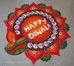 a decorated rangolim with the words happy diwali written on it