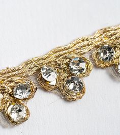 a gold chain with lots of crystal stones on it