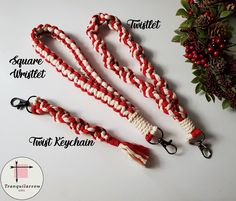 red, white and black braided lanyard with tassels attached to it