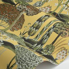 a yellow wallpaper with an image of plants and flowers printed on the back of it