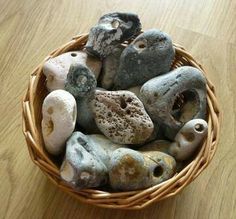 a basket filled with rocks sitting on top of a wooden table