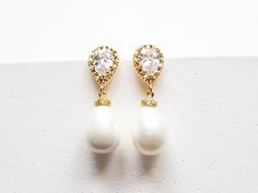 Pearl teardrop bridal Earrings in gold, silver and rose gold. A gorgeous cream shell pearl tear drop on a gold cubic zircon tear drop earring post. A extremely elegant designs. Very versatile, perfect for a bride or even as a gift for bridesmaid or mother of bride. Details: Material: 16k gold, rhodium or rose gold plated brass, cubic zircon Length: approx 1.5 inches Earrings ONLY, Matching necklace available at extra cost - https://www.etsy.com/listing/246313605 This item is in-stock and ready t Pear-shaped Pearl Charm Wedding Earrings, Gold Drop Bridal Earrings With Pearl Charm, Gold Dangle Drop Earrings For Wedding, Gold Pear-shaped Pearl Earrings For Wedding, Gold Pear-shaped Bridal Earrings With Pearl Charm, Teardrop Wedding Earrings With Pearl Charm, Wedding Teardrop Earrings With Pearl Charm, Elegant Gold Drop Earrings For Wedding, Pearl White Teardrop Pear-shaped Earrings For Wedding