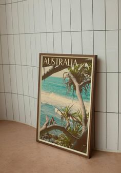 an australian poster on the wall next to a white tiled wall with blue and green water