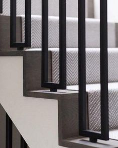 some black and white stairs with metal handrails