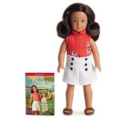 an american girl doll and book on a white background