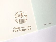 the logo for village du courant is shown on top of two envelopes