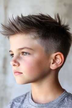 Save this pin for the best boys haircuts for school. This faux hawk offers an edgy look with a spiky top for added height and texture. The shorter sides keep it manageable. Spiky Boys Haircut, Faux Hawk Boy, Faux Hawk Boys, Boys Faux Hawk, Best Boys Haircuts, Haircuts For School, Fohawk Haircut, Spikey Short Hair, Spikey Hair