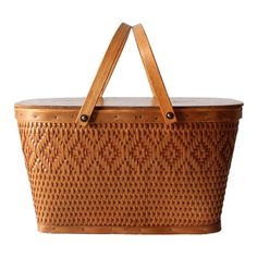 a brown woven basket with leather handles