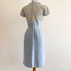 Beautifully tailored vintage 1960s dress has a bodice and front pockets cut from cream embroidered cutwork. Bodice has a little rounded collar and covered buttons; bust area is lined in cream organza. Seamed and darted for a fitted shape; skirt has tiny gathers at the front sides and a back kick pleat. Feels like linen or a linen blend. In very good condition with some light discoloration - not staining, more like fading - to the hem and back collar area as shown.  No designer tags but labeled a size 10. Shown on a 34-24-35 dress form and fits like an XS; laid flat across armpits 16" but front max is 19" due to the darts; across waist 12.5", hip 17", high point of shoulder to waist 17", waist to hem 24". Cutwork Lace, Vintage Dresses 1960s, 1960s Dress, 1960's Dress, 60s Mod, Kick Pleat, 1950s Dress, Wiggle Dress, Dress Form