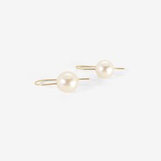 Details Rosanne Pugliese 18k yellow gold & cream-colored South Sea pearl earrings on minimalist ear wires. The pearls measure 7/16" x 7/16"(11mm) & the earrings measure approximately 1″ from the top of the minimalist ear wire to the bottom of the pearl. - 7/16" (8mm) diameter South Sea pearls - 18k yellow gold - 1" total length - each earring weighs 2.61g Classic Round Pearl Earrings With French Hook, Minimalist Akoya Pearl Earrings In Yellow Gold, Classic Single Pearl Earring In 14k Gold, Minimalist Yellow Gold Akoya Pearl Earrings, Single Classic Pearl Earring In 14k Gold, Classic Single 14k Gold Pearl Earring, Gold Akoya Pearl Earrings With Ear Wire, Minimalist Akoya Pearl Round Earrings, Minimalist Round Akoya Pearl Earrings