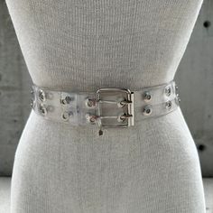 Y2K transparent double grommet belt, two row eyelet belt, hollow gothic style, grunge punk fashion, pop culture, maximalist chic aesthetic Step into the rebellious allure of Y2K fashion with this Transparent Double Grommet Belt - a nod to the iconic era of pop culture and grunge punk fashion. The edgy design features two rows of meticulously crafted eyelets, creating a strikingly hollow gothic style that merges seamlessly with contemporary maximalist chic aesthetics. Crafted with precision, the transparent material adds a futuristic touch, allowing your outfit to peek through the double grommet details. This belt is a sartorial statement, effortlessly capturing the essence of Y2K rebellion and bold self-expression. The grunge punk vibes are amplified by the industrial-inspired grommets, ex Grunge Punk Fashion, Y2k Transparent, Double Grommet Belt, Eyelet Belt, Oversized Band Tee, Grommet Belt, Edgy Design, Chic Aesthetic, Transparent Material