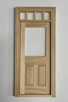 a wooden door with glass inserts on the front and side panels, hanging on a wall