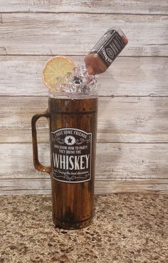 a wooden mug filled with ice and an orange slice