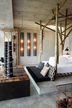 a bed sitting in the middle of a bedroom next to a wooden structure with lights on it