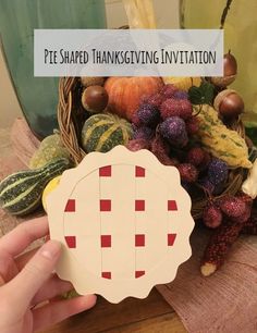 a hand holding a piece of wood with the words pie shaped thanksgiving in it