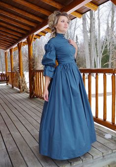 Civil War Era styled cotton dress has dropped shoulder, fitted bodice, full skirt, and double puffed sleeves with flounce. The bodice front is shaped by four darts and the closure is in the front with metal buttons. There is a short collar. The back bodice has a center back piece and 2 side back panels. The full skirt is gathered to the waistline. Hand or machine wash, tumble or air dry. Designed and made proudly in America by Recollections. Alicia is wearing boots, ruffled hoop, and jewelry and 19th Century Dress, Edwardian Costumes, 1850s Fashion, Victorian Elegance, Century Dress, Bustle Dress, Old Fashion Dresses, Celebrity Design, Historical Dresses