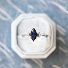 an engagement ring with a blue stone in the middle