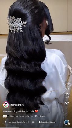 the back of a woman's head with long black hair and a tiara