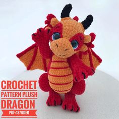 a crocheted red and orange dragon sitting on top of a white countertop