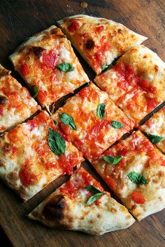 a pizza cut into eight pieces on top of a wooden table