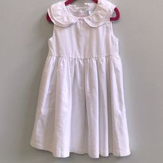 In New Condition. Sleeveless, Layered Collar And Lined With Button Closure. Spring School Dress With Peter Pan Collar, White Button-up Dress For Dress-up Occasion, White Sleeveless School Dress, White Dress With Buttons For Dress-up, Cotton School Dresses With Buttons, Classic Cotton Dresses For Dress-up, Classic Cotton Dresses For Dress-up Occasions, Classic Cotton Dress For Dress-up Occasions, Spring School Dresses With Buttons